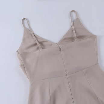 Beige adjustable strap cami top featuring a versatile design, perfect for summer wear. The cami has a zipper detail and is displayed alongside stylish fashion accessories including a hobo bag and shoulder bag.