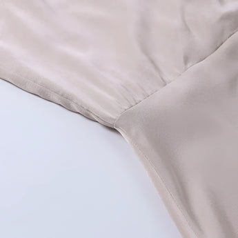 Beige adjustable strap cami top with zipper, featuring a sleeveless design and a simple, versatile style perfect for summer wear.