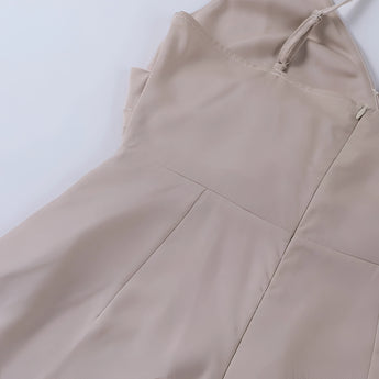 Beige adjustable strap cami top with a zipper, featuring a versatile design ideal for summer wear.