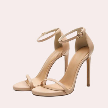 Beige ankle strap stiletto heels with an elegant platform design, showcasing high heels and sleek sandal style, ideal for formal occasions or bridal wear.