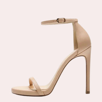 Beige ankle strap stiletto heels featuring an elegant platform design, suitable for bridal wear, showcasing a fashionable court shoe appearance with a sleek high heel.