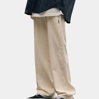 Beige high-waisted wide-leg trousers with a baggy fit, designed for a casual streetwear style.