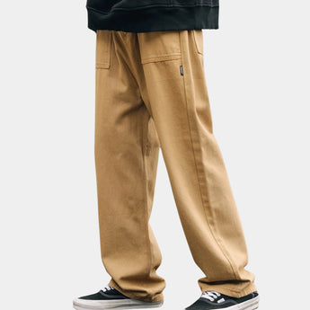Beige baggy high-waisted wide-leg trousers in a casual streetwear style, shown in a persimmon color, featuring a relaxed fit with emphasis on the thigh and knee areas.