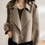 Beige biker jacket made from a textured wool blend, designed for women. The jacket features a structured collar, full sleeves, and falls to the waist. It has a fashionable design suitable for fall, shown in a cachi color and size 2XL.