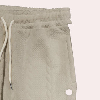 Beige chevron textured elastic waist sweatpants with a cozy and comfortable design, suitable for lounging.