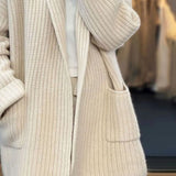 Beige chunky knit oversized women's cardigan with pockets, featuring long sleeves and a cozy, soft texture.