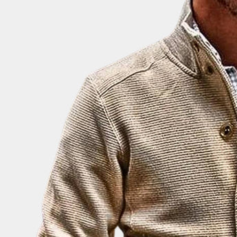 Men's beige corduroy blazer with long sleeves and a notched collar, worn over a dress shirt. The lightweight jacket is styled for fall fashion, showcasing a sophisticated and casual look.