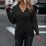 A woman wearing a black XXL crew neck sweater, showcasing a casual fall fashion look. She is standing with her arms relaxed, highlighting the sweater's comfortable fit on her shoulders and waist. The sweater features long sleeves and is suitable for a stylish, cool-weather outfit.
