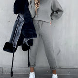 A beige crew neck t-shirt made from soft cotton, designed for minimalist everyday wear, displayed on a person.