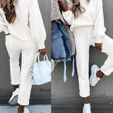 Beige crew neck t-shirt worn by a person, emphasizing its soft cotton fabric and minimalist design, with a focus on the shirt's fit around the shoulder and sleeve area.