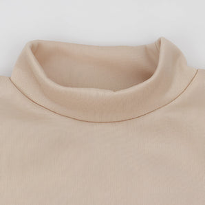 Beige crew neck t-shirt made from soft cotton, featuring minimalist design and short sleeves, displayed on a wooden background.