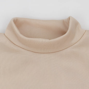 Beige crew neck t-shirt made from soft cotton, featuring minimalist design and short sleeves, displayed on a wooden background.