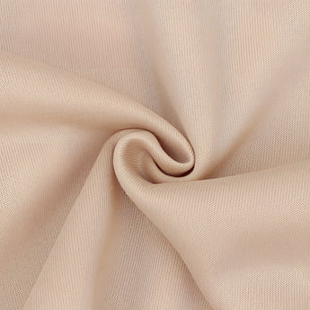 Beige crew neck t-shirt made from soft cotton, featuring a minimalist design with short sleeves and a simple collar.