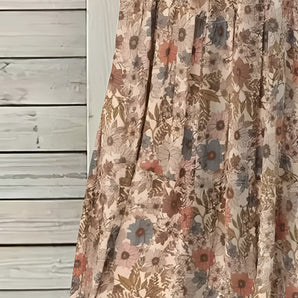 Beige floral A-line midi skirt featuring a vintage style, perfect for spring and summer wear.