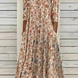 Beige floral A-line midi skirt with a vintage style, featuring a delicate floral pattern suitable for spring and summer fashion.