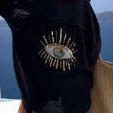 
A black knit crop top featuring a short sleeve design, suitable for women's summer fashion and chic beachwear. The close-up image highlights the shoulder and neckline details against a light background.