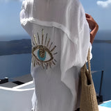 Beige knit crop top for women, featuring a chic summer fashion design with short sleeves and a pattern detail, set against a clear sky background.