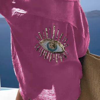 A pink knit crop top designed for women's summer fashion and chic beachwear, featuring shoulder-length sleeves against a backdrop of a clear blue sky.