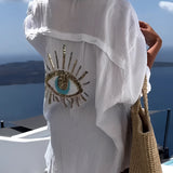 Beige knit crop top for women featuring short sleeves, designed for summer fashion and chic beachwear, set against a clear sky backdrop.