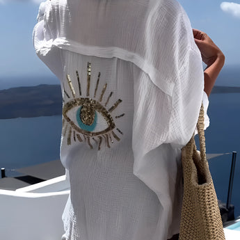 Beige knit crop top for women featuring short sleeves, designed for summer fashion and chic beachwear, set against a clear sky backdrop.