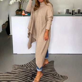 Beige knit oversized cardigan on a woman standing, showcasing its long sleeves and relaxed fit, ideal for fall fashion.