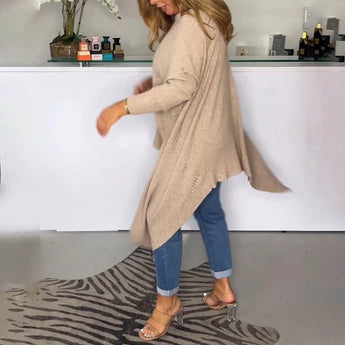 Beige knit oversized cardigan for women, featuring a cozy and stylish design ideal for fall fashion. The sweater has long sleeves and hangs loosely over the shoulders, covering down to the thighs, perfect for layering.