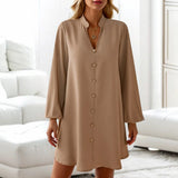 Beige lantern sleeve shirt dress in a camel color, featuring a button-front design with a mini length. The dress has a defined waist, prominent collar, and is designed for a casual style.