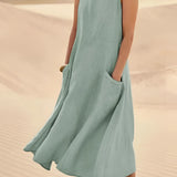 Beige linen dress with pockets, worn by a person, featuring a comfortable design suitable for eco-friendly summer fashion. The dress is styled with a green pin and is available in size 5XL.
