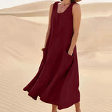 Dark red linen dress with a relaxed fit, featuring short sleeves, a round neckline, and practical pockets. This eco-friendly summer dress falls to the knee, offering a fashionable and comfortable style suitable for casual daytime wear.