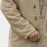 Beige linen mandarin collar shirt with long sleeves, designed for a lightweight summer style, shown on a mannequin.