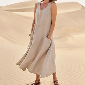 Beige sleeveless linen maxi dress featuring a V-neck design with pockets, shown in size 3XL. The dress elegantly flows down to the thighs, suitable for summer wear.