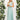 Beige maxi dress featuring a crisscross back, tie waist, and a flattering one-piece design, ideal for wedding guest attire.