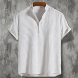 Men's short sleeve pleated dress shirt in beige, featuring a relaxed fit with a collar and button-up front, displayed on a clothes hanger.