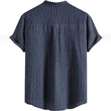 Beige men's short sleeve pleated shirt with a collar and button front, designed in a relaxed fit for summer wear.