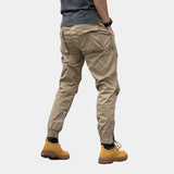 Beige men's slim fit cargo pants featuring a durable design with multiple pockets, suitable for outdoor wear. The pants are styled in a khaki color, showcasing a fashionable and functional look.