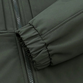 Beige men's waterproof breathable jacket featuring long sleeves, a collar, and a comfortable textile material designed for outdoor adventures. The jacket is styled in neutral tones with subtle patterns, emphasizing fashion and functionality.