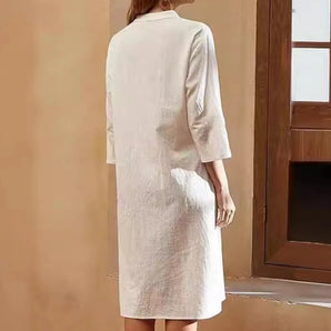 Beige mid-length linen dress with 3/4 sleeves, lightweight and breathable, displayed on a mannequin.