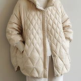 Beige oversized hooded puffer jacket with a lightweight design, featuring a high collar, long sleeves, and a fashionable fit, suitable for winter wear.