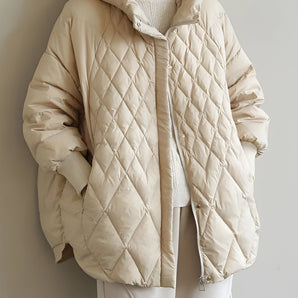 Beige oversized hooded puffer jacket with a lightweight design, featuring a high collar, long sleeves, and a fashionable fit, suitable for winter wear.