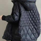 
An oversized beige hooded puffer jacket designed as a lightweight winter coat, featuring long sleeves and a quilted texture. The jacket is worn by a person standing and showcases elements like the shoulder, neck, and waist area.