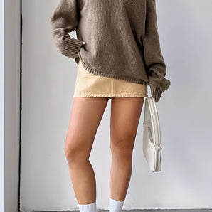 Beige oversized off-shoulder knit sweater displayed on a mannequin, highlighting the wide neckline, loose fit, and long sleeves, perfect for trendy fall fashion.