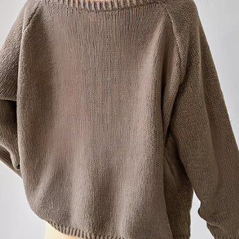 Beige oversized off-shoulder knit sweater featuring a trendy fall fashion design with long sleeves and a cozy neckline.