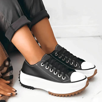 A pair of beige platform sneakers with chunky soles and star heel details, styled for women's streetwear, shown in Corvinus Black, size 43.