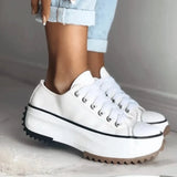 Beige platform sneakers with chunky sole featuring star heel detail, styled for women's streetwear.