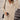 Beige ribbed knit button-up sweater dress in size 3XL, showcased in a fall street style setting. The dress features a button-up front and long sleeves, creating a cozy yet fashionable look suitable for cooler weather.