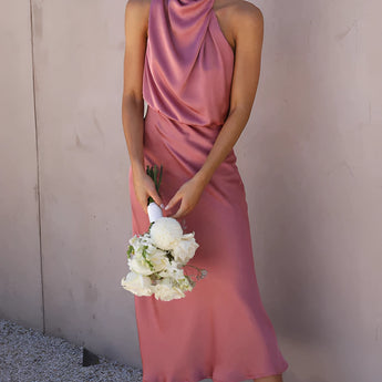 Beige sleeveless backless midi dress in baked rose color, designed for elegant wedding and cocktail wear. The dress features a one-piece garment style, highlighting shoulders and neck, suitable for formal occasions.