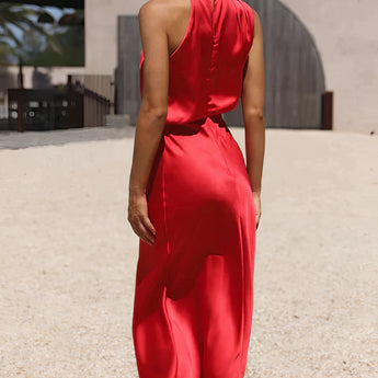 Beige sleeveless backless midi dress featuring an elegant design suitable for weddings and cocktail events, showcasing a flattering waistline and sophisticated neckline.