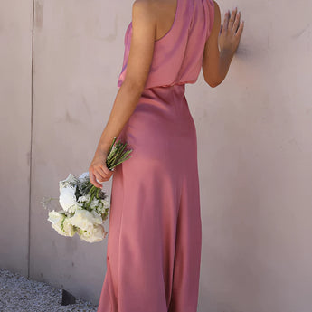 Beige sleeveless midi dress with a backless design, ideal for elegant weddings and cocktail events.