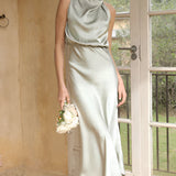 Olive 3XL sleeveless backless midi dress, perfect for elegant wedding or cocktail wear, showcasing a form-fitting design with emphasis on waist and neck, featuring details on hair and legs.