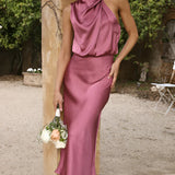 Beige sleeveless backless midi dress in plum color, featuring elegant design suitable for weddings and cocktail events, displayed on a mannequin against a neutral background.